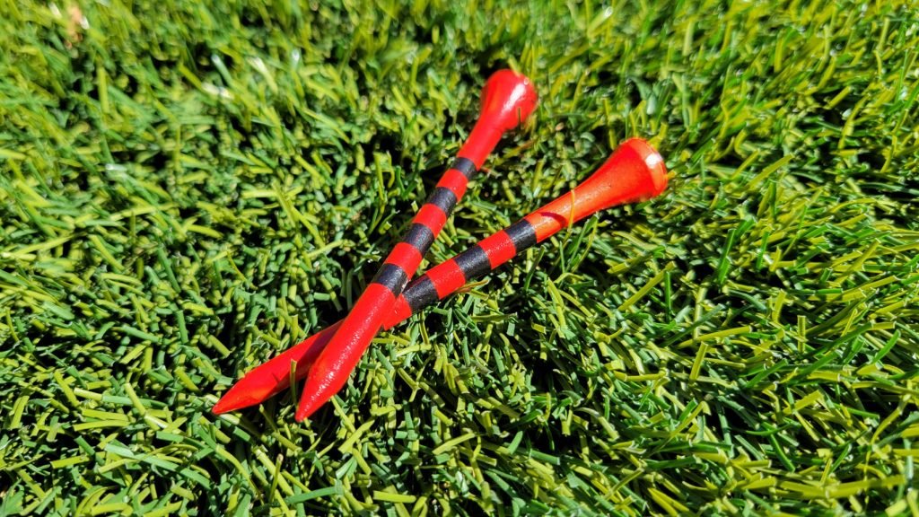 red wooden golf tees with black precision height stripes