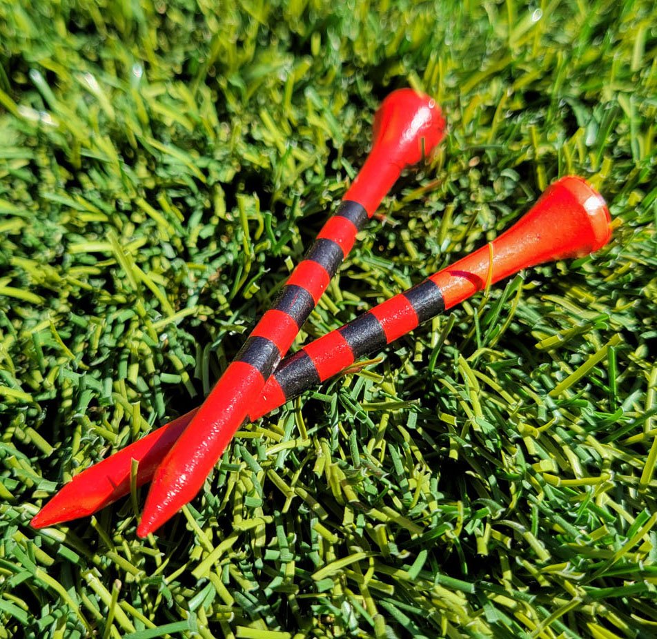 red wooden golf tees with black precision height stripes